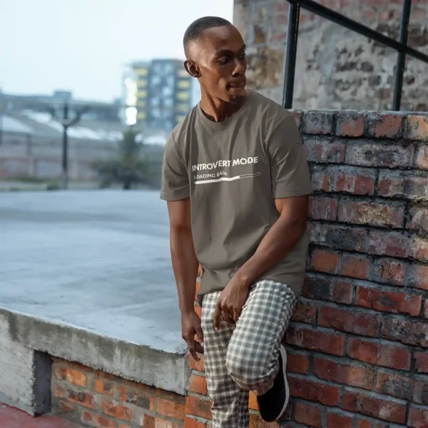 Man wearing an asphalt Bella-Canvas t-shirt with white Introvert Mode print