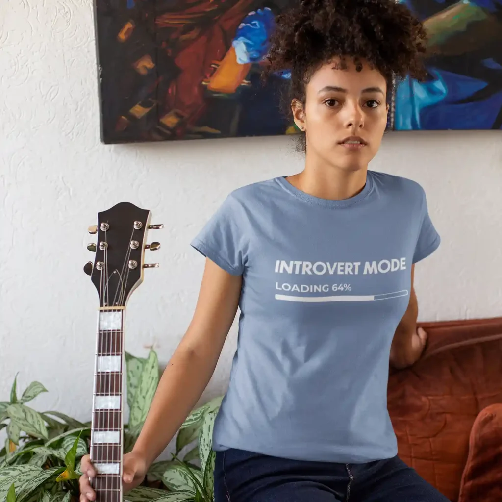 Woman wearing a lavender blue Bella-Canvas t-shirt with white Introvert Mode print