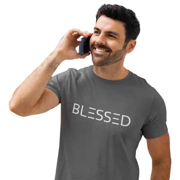 Man speaking in phone wearing an asphalt Bella-Canvas t-shirt with white Blessed print