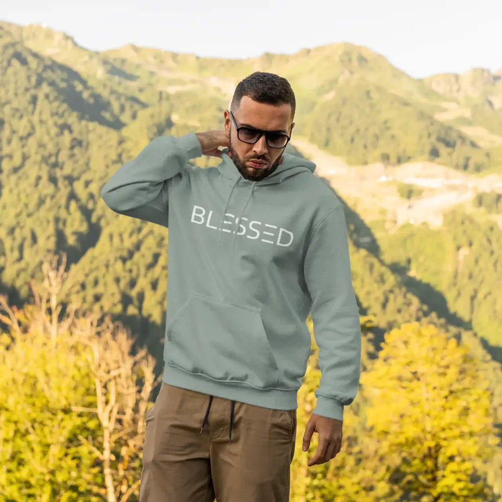 Man wearing dusty green Just Hoods hoodie with white Blessed print