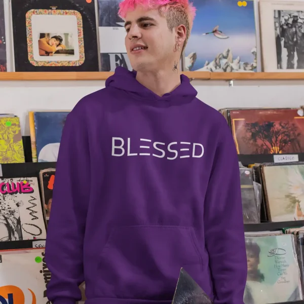 Young man wearing purple Just Hoods hoodie with white Blessed print