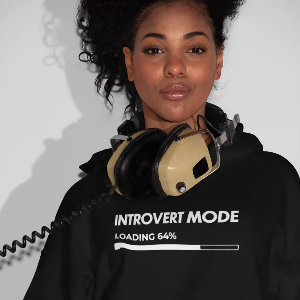 Young woman wearing a jet black Just Hoods hoodie with white Introvert Mode print