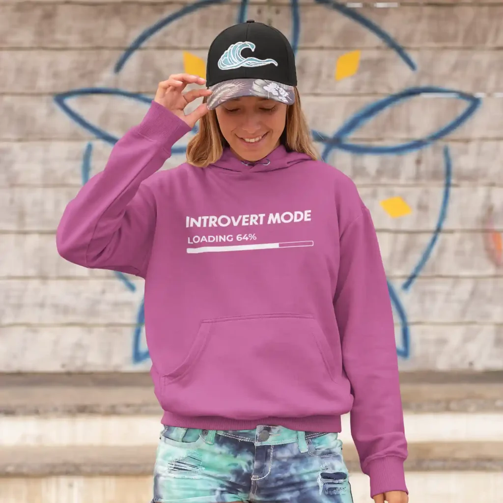 Young woman wearing a pinky purple Just Hoods hoodie with white Introvert Mode print