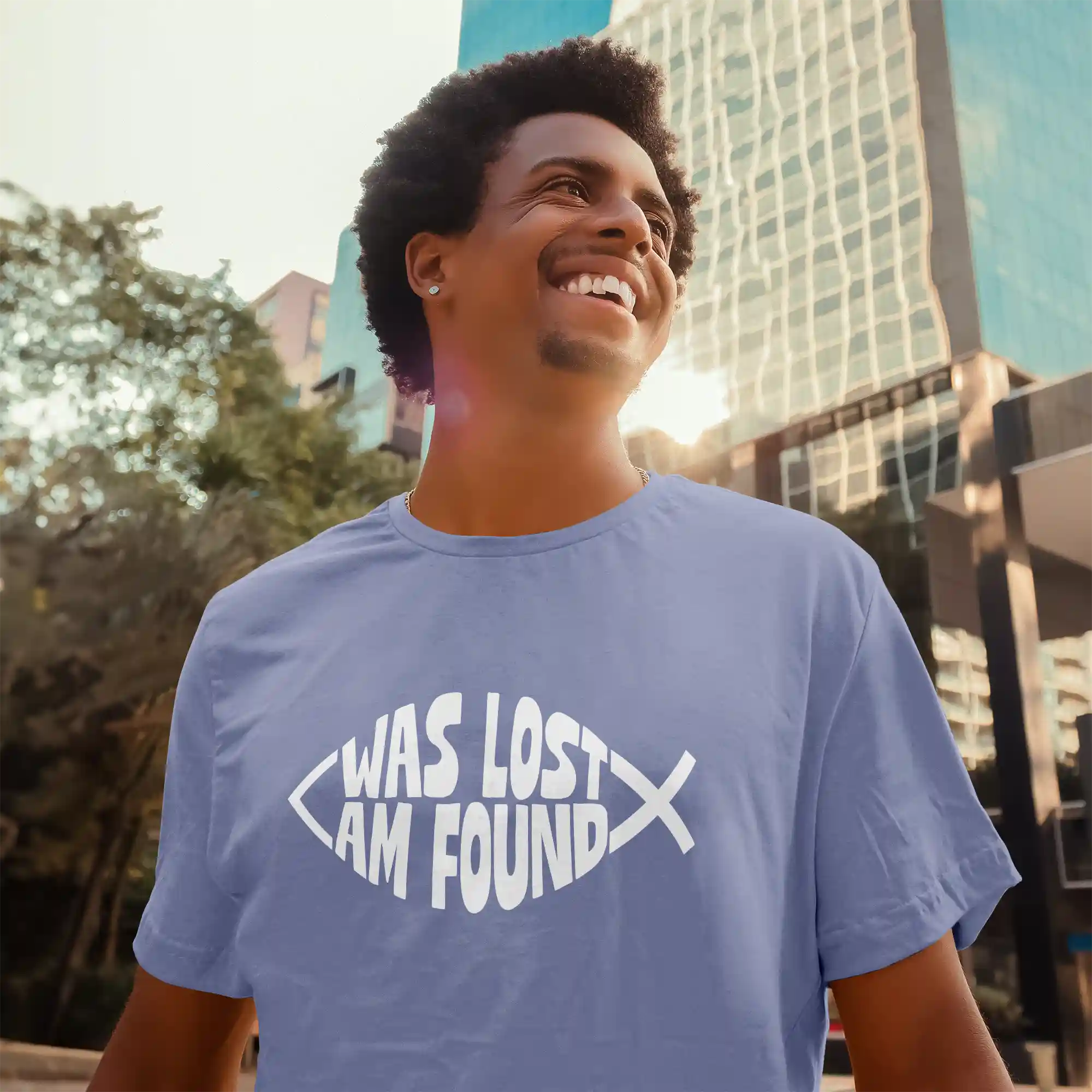 Man wearing a lavender blue Bella-Canvas t-shirt with white Found print