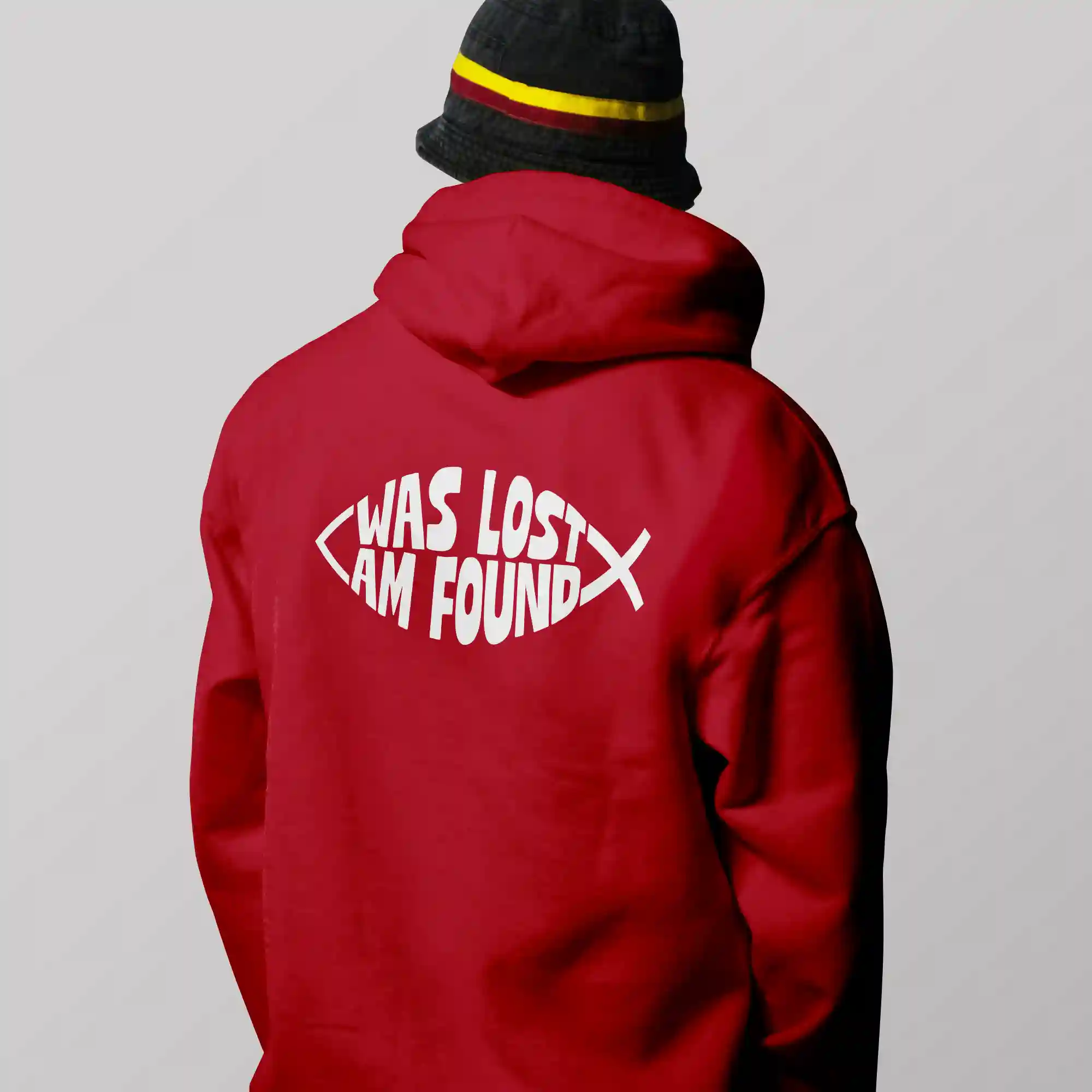 Man wearing a red Just Hoods hoodie with white Found print on the back