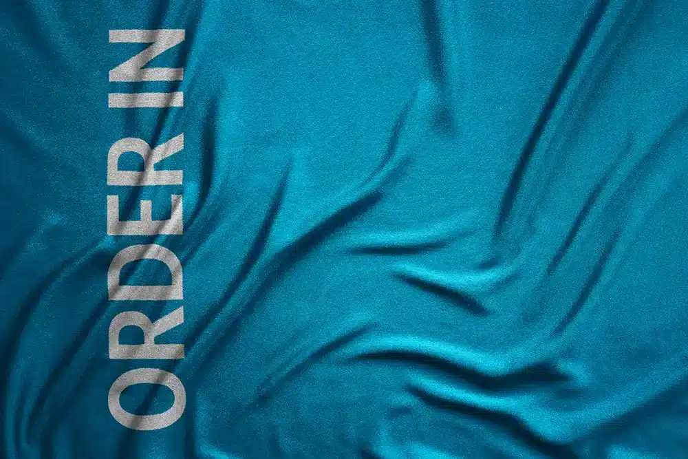 Order In print on blue fabric