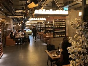 Fazenda bar with tables and wine bottles and flowers in foreground