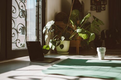 a laptop and a cup on the floor