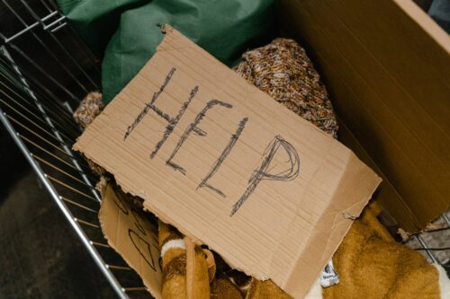 a cardboard with the word help written