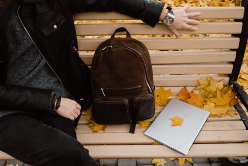 person sitting on a wooden bench