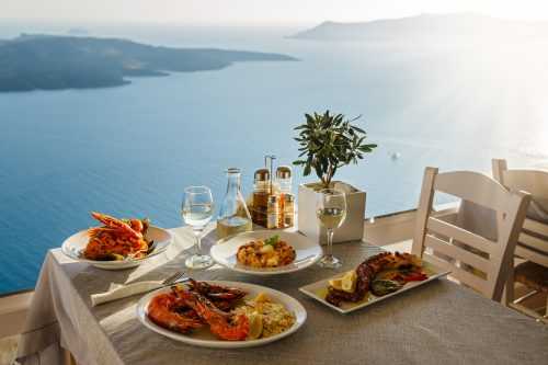 Picture of seafood dinner for two people overlooking the water in Santorini, Greece