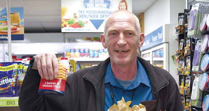 Customer holds free cheese and onion slice