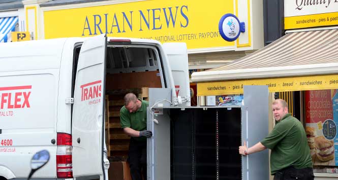 loading Arian News' tobacco gantry into a van