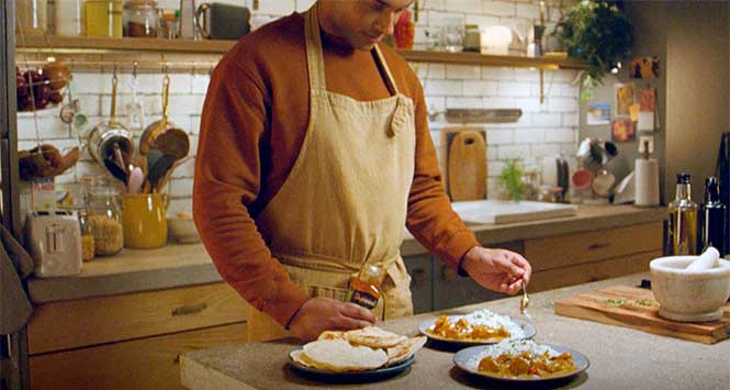 Man cooking with Sharwood's sauce