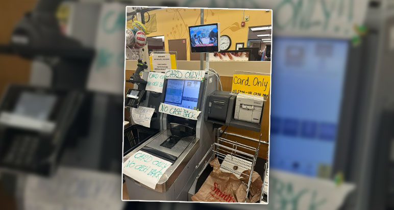 Self-service till plastered with 'card only' signs