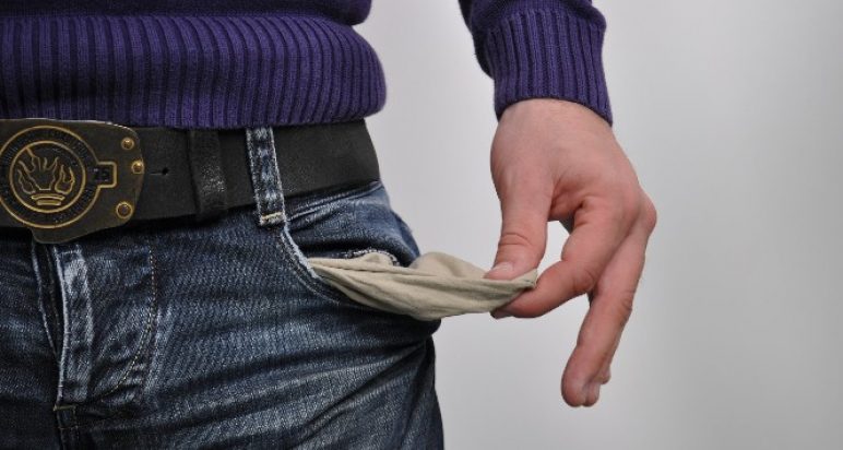 Image of man searching his pockets for money