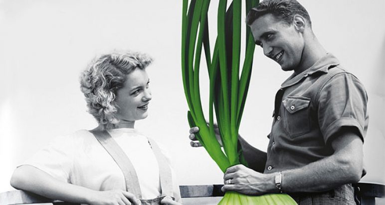 Woman smiling at a man's massive root vegetable