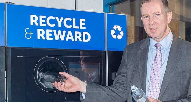 John Brodie feeds reverse vending machine