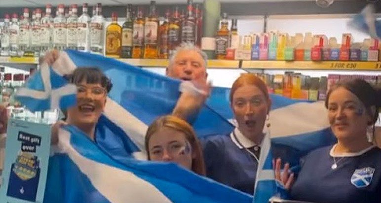 Shop staff waving saltires