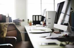 Empty, cluttered desk someone is to return to