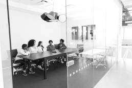 Team photographed sitting in conference room