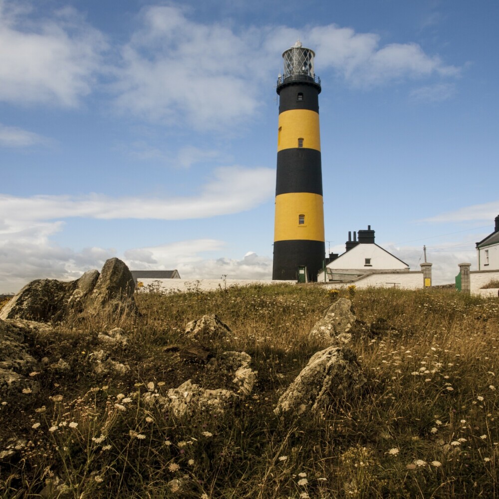 Low angle shot of the St John's Point lighthouse in Killough on Dundrum Bay in Northern Ireland Taxi Tours Antrim