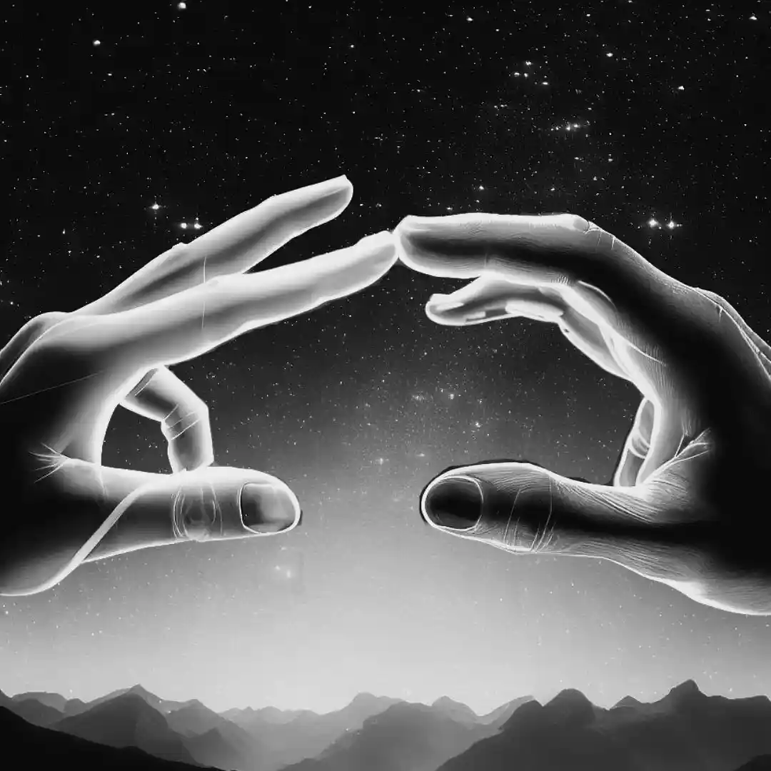 Fingers touching each other in front of a starry sky