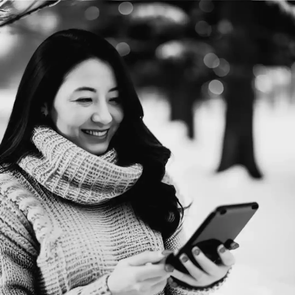 Smiling woman looking at her smartphone