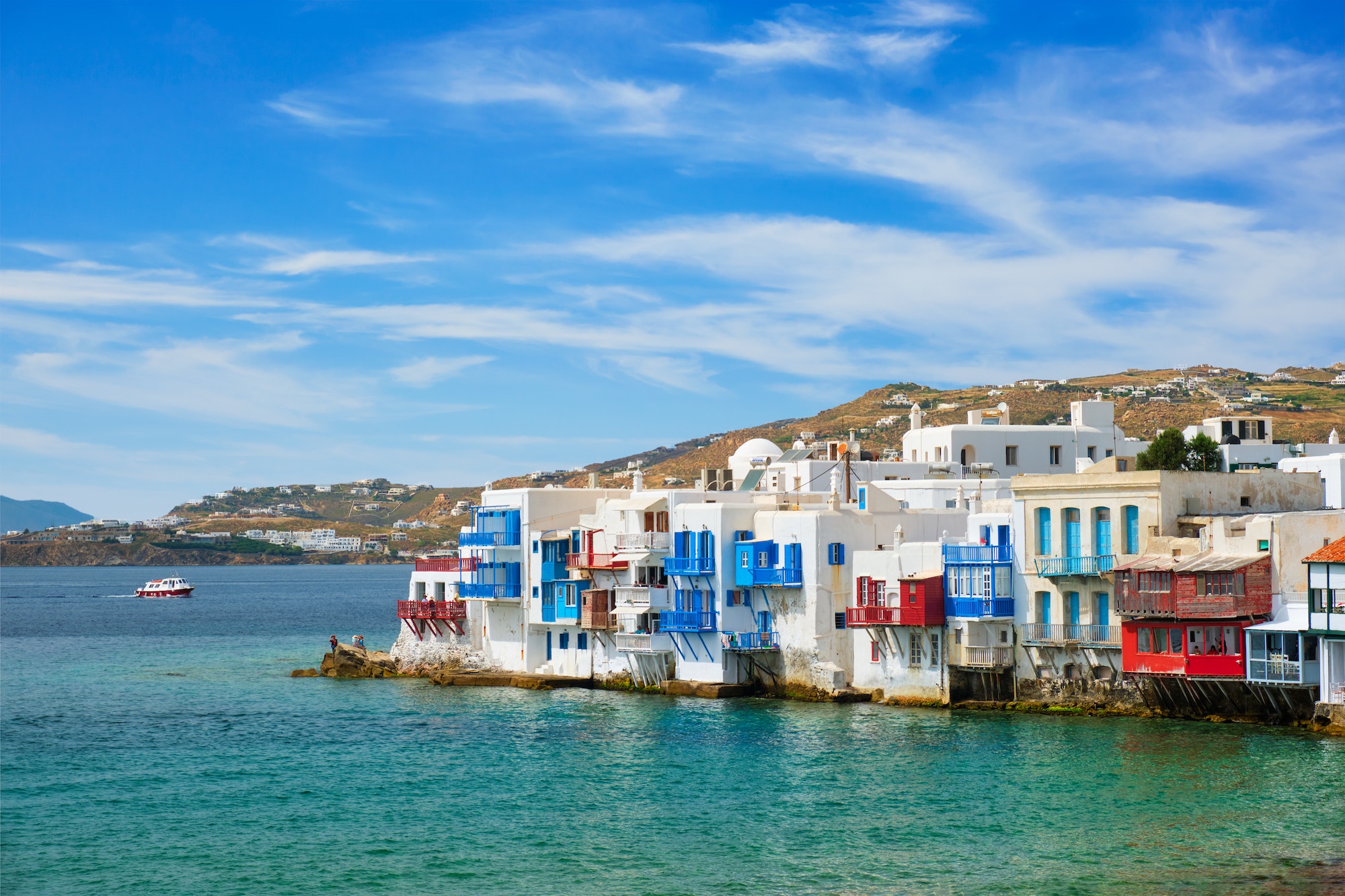 Little Venice houses in Chora Mykonos town with yacht and cruise ship. Mykonos island, Greecer