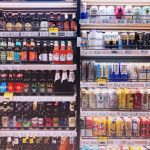 assorted bottles and cans in commercial coolers
