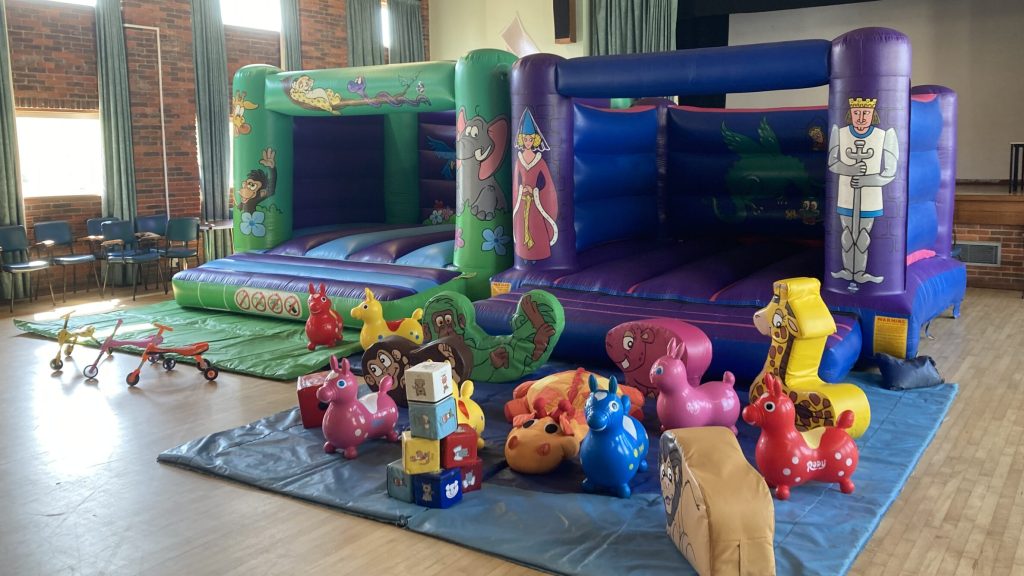 Two bouncy castles with soft play for birthday party in Peartree Church Hall