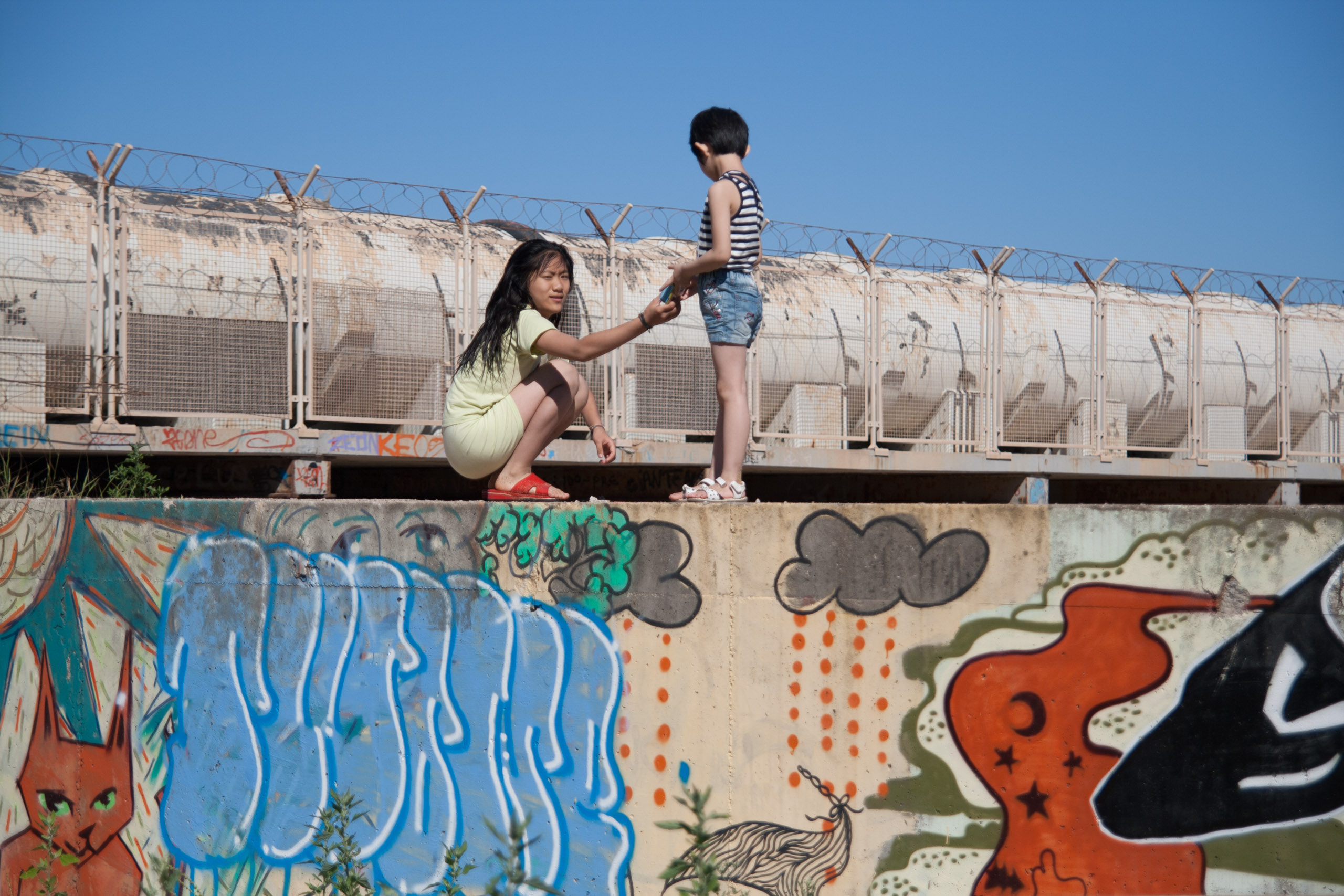 Girl and boy on grafitti wall