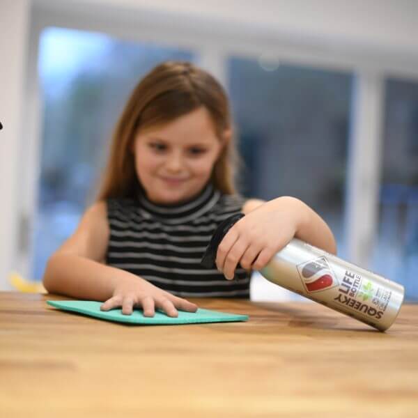 Child cleaning with squeeky life bottle