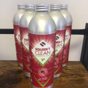 Five bottles of Squeeky natural plastic free washing up liquid on a shelf