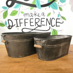 Different sized distressed metal trough planters