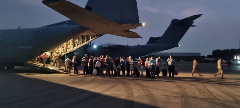 Italian citizens can be seen boarding an Italian Air Force C130 aircraft during their evacuation from Khartoum, Sudan, in this undated photo obtained by Reuters on April 24, 2023. (Photo credit: Ministero della Difesa/Handout via REUTERS)