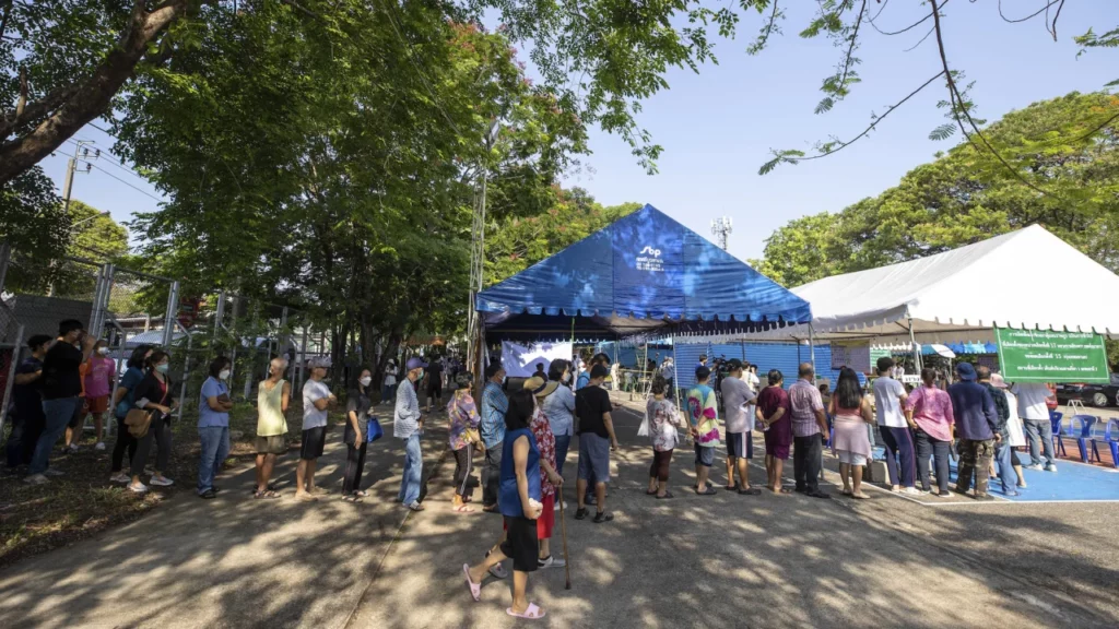 Voters wait in line outside a polling station to cast their vote in Bangkok, Thailand on Sunday, May 14, 2023.