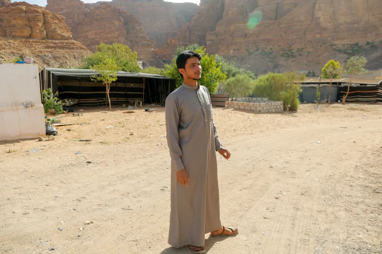 Salman, Al-Zalabeih's grandson, engages with year-round tourists.