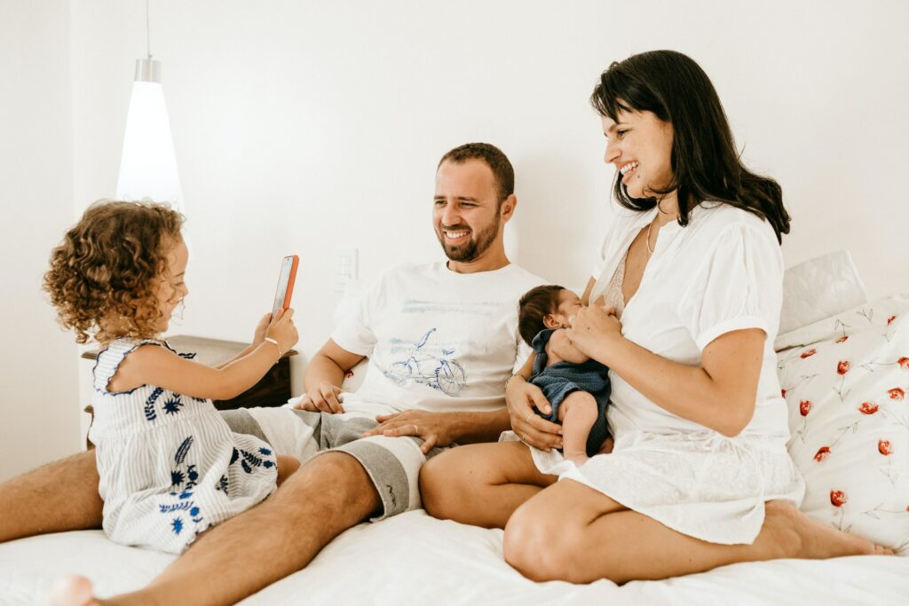 The Global Day of Parents: Celebrating the Vital Role of Parents in Shaping the Future of Society man in white crew neck t-shirt sitting beside woman in white crew neck t-shirt