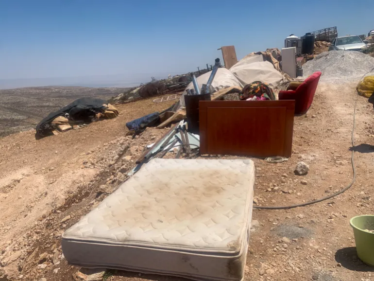 The belongings of the Kaabneh family scattered outside the tent, unable to accommodate even a full-size mattress.
