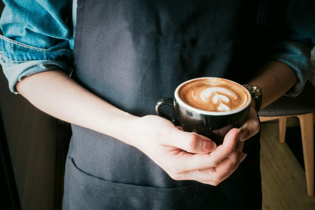 The History of Coffee: Tracing the Evolution of a Beloved Beverage Woman Holding Mug of Cappuccino