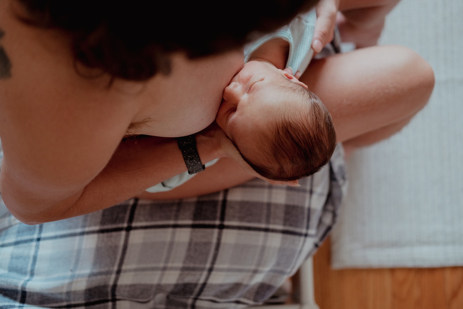 Breastfeeding a woman holding a baby in her lap