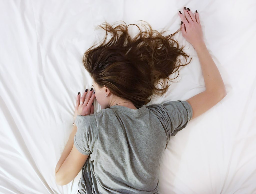 How to Improve Your Sleep Quality Naturally: A Comprehensive Guide woman laying on bed
