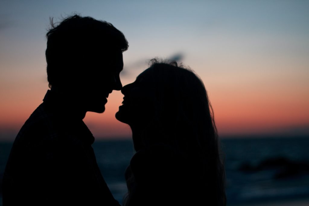 How to Improve Communication in Your Relationship silhouette of man and woman about to kiss on beach during sunset