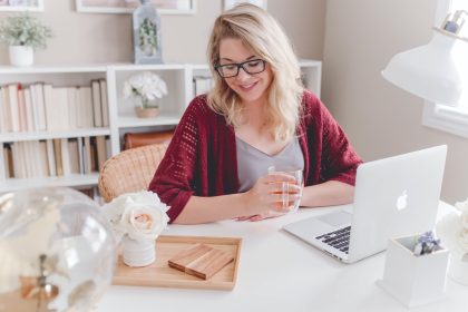Protecting Your Privacy and Security Online: A Comprehensive Guide Security Online woman smiling holding glass mug sitting beside table with MacBook