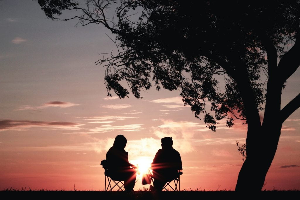 How to Improve Communication in Your Relationship silhouette of two person sitting on chair near tree