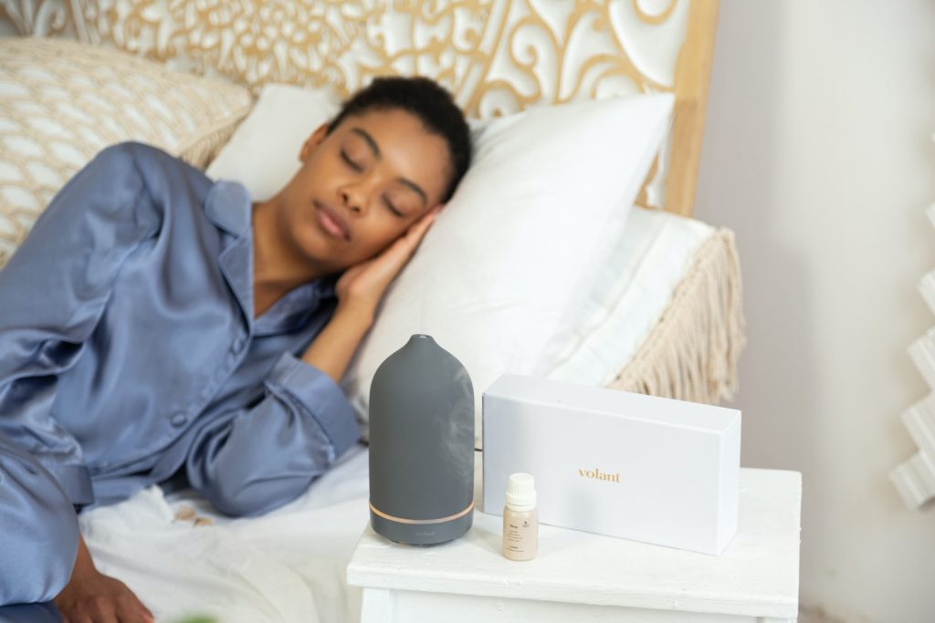 How to Improve Your Sleep Quality Naturally: A Comprehensive Guide a woman laying on a bed next to a night stand