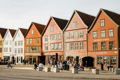 people walking beside house Bryggen