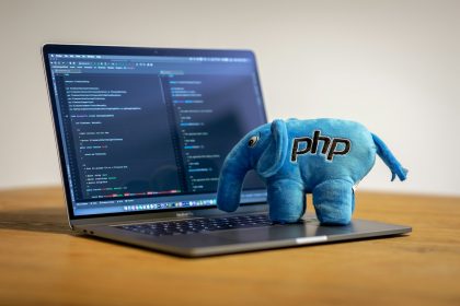 blue elephant plush toy on black laptop computer