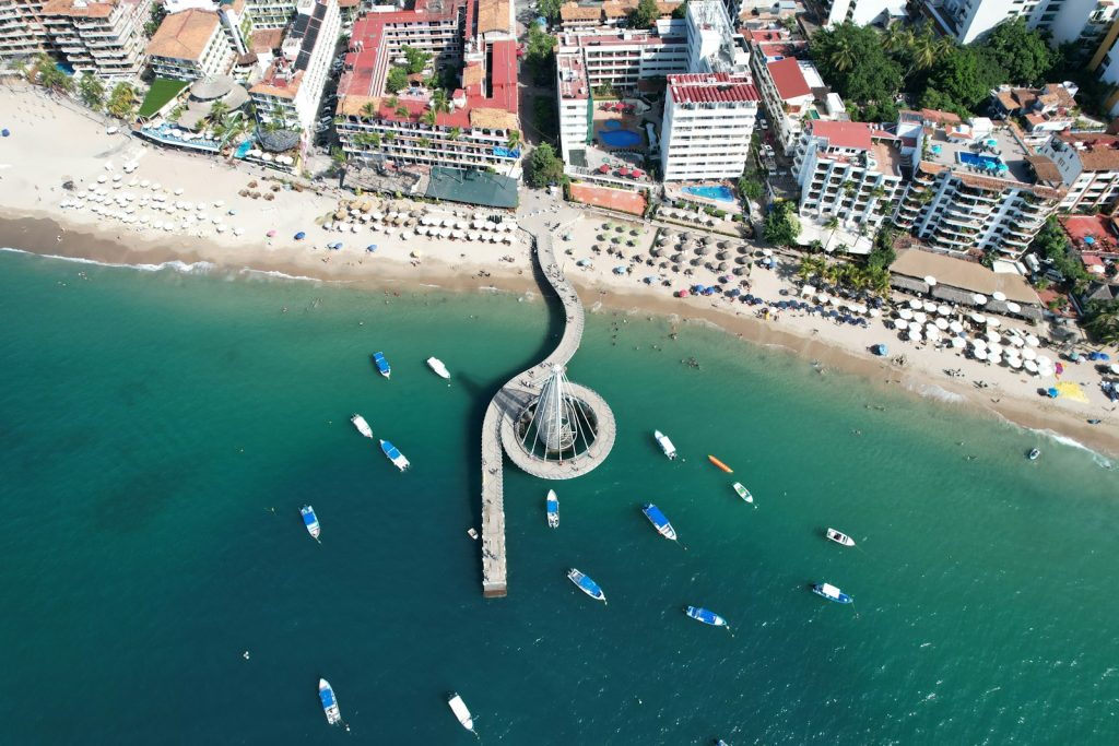 an aerial view of a beach with boats in the water Puerto Vallarta Embracing Diversity